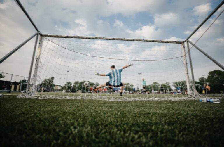 Goalkeeper in Goal Green Grass Cloudy Sky
