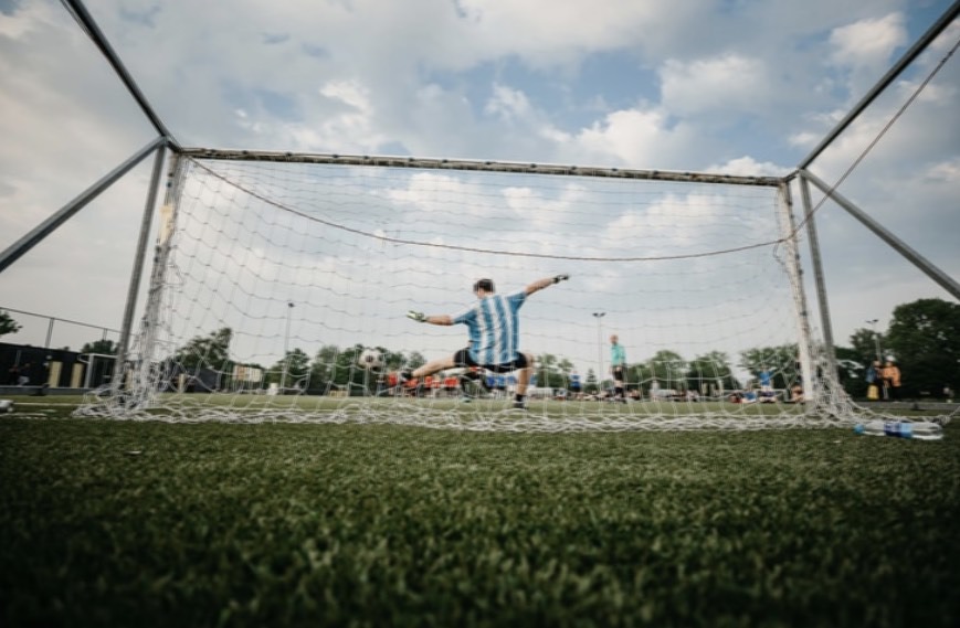 Goalkeeper in Goal Green Grass Cloudy Sky
